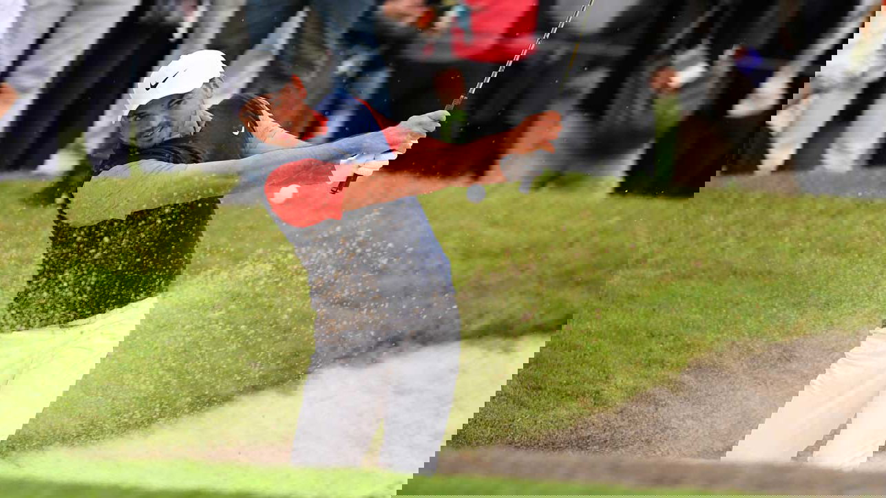 Jason Day splashes out of a greenside bunker with a 6 iron